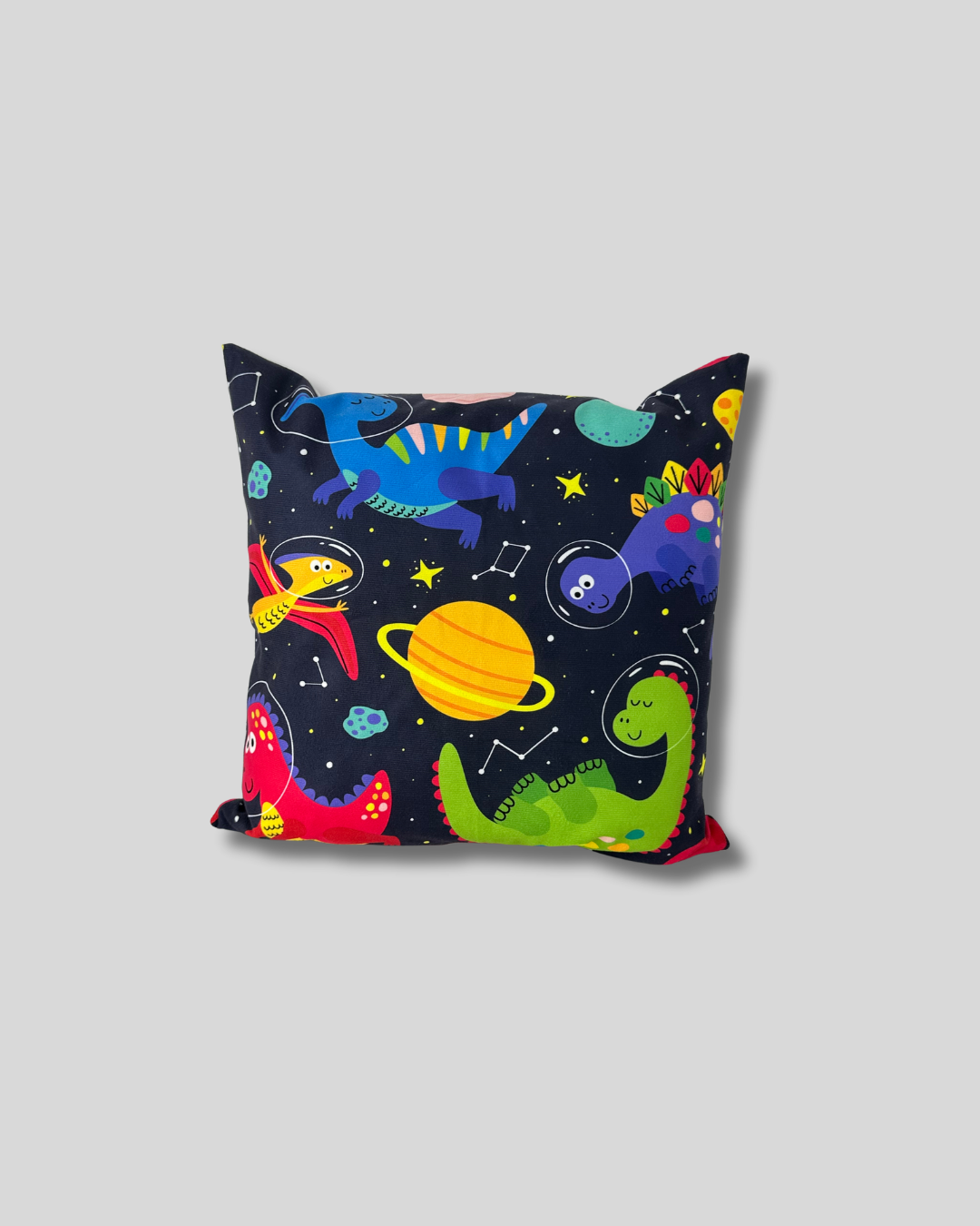 Cojín de dinosaurios y galaxia